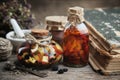 Bottles of essential oil or infusion, mortar and book. Herbal medicine