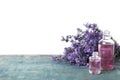 Bottles of essential oil and lavender flowers on blue wooden table Royalty Free Stock Photo