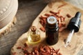 Bottles of essential oil with red sandalwood chips