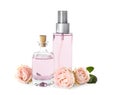 Bottles of essential oil and roses on white Royalty Free Stock Photo