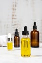 Bottles with essential oils on the cosmetic table in the bathroom. A set of organic cosmetics in glass vials with dropper for skin