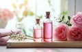 Bottles of essential rose oil and flowers on wooden table Royalty Free Stock Photo