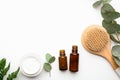Bottles of eucalyptus essential oil, cream and brush on white background Royalty Free Stock Photo