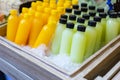 Bottles of fresh juice in a wooden bucket filled with ice Royalty Free Stock Photo