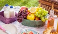 Bottles of fresh milk, juice and fruit at a picnic