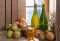 Bottles and glass of cider with apples