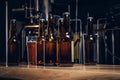 Bottles and glass of craft beer on wooden bar counter at the indie brewery.