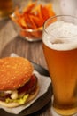 Bottles and glasses of beer with hamburgers Royalty Free Stock Photo