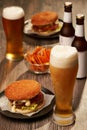 Bottles and glasses of beer with hamburgers Royalty Free Stock Photo