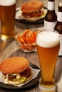 Bottles and glasses of beer with hamburgers Royalty Free Stock Photo