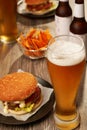 Bottles and glasses of beer with hamburgers Royalty Free Stock Photo