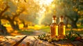 Bottles of olive oil on wooden table in sunny orchard. This is a concept of natural products and healthy living Royalty Free Stock Photo