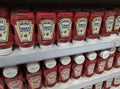 Bottles of Heinz Ketchup stacked on shelves.