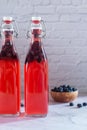 Bottles of homemade blueberry kombucha drink.