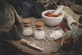 Bottles of homeopathic globules, mortar of dried chili pepper, dry roots, nuts and plants. Homeopathy. Royalty Free Stock Photo