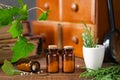 Bottles of homeopathy granules, cabinet with homeopathic remedies and old books on background. Homeopathy medicine Royalty Free Stock Photo