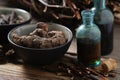 Bottles of infusion of Persicaria bistorta and Common comfrey roots. Bowl of Bistort, Snakeweed, Snake roots. Dried