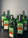 Bottles of Jagermeister spirit liqueur displayed on a black metal shelf