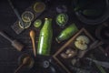 Bottles and jar with green smoothie and different ingredients on the wooden tray horizontal Royalty Free Stock Photo