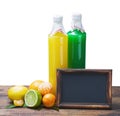 Bottles of juice from citrus fruits and blackboard Royalty Free Stock Photo