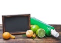 Bottles of juice from citrus fruits and blackboard Royalty Free Stock Photo