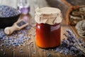 Bottles of lavender salve, balm or cream, lavender flowers, book and essential oil bottle on table. Herbal medicine Royalty Free Stock Photo