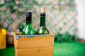 Bottles of liquor alcohol in a cardboard box getting home delivered online kept in the garden at the threshold of a home