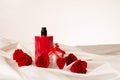 Bottles of male and female perfume, red roses, decorative hearts on the satin fabric background. Cosmetics Royalty Free Stock Photo