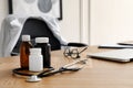 Bottles with medicaments, laptop and stethoscope on table, space for text. Modern medical office interior