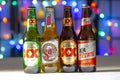 Bottles of Mexican beer on a white texture surface on a colourful lights