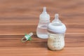 Bottles with milk for feeding baby on wooden background Royalty Free Stock Photo