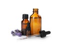 Bottles with natural lavender oil, flowers and dropper on white Royalty Free Stock Photo