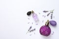 Bottles of natural perfume and lavender flowers on background, top view. Cosmetic products