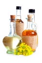 Bottles of oil with rapeseed flower Royalty Free Stock Photo