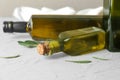 Bottles with olive oil on light table Royalty Free Stock Photo