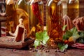 Bottles of olive oil with various spices and vintage cooking utensils Royalty Free Stock Photo