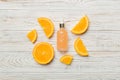 Bottles with orange fruit essential oil on wooden background. alternative medicine top view with copy space Royalty Free Stock Photo
