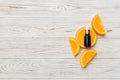 Bottles with orange fruit essential oil on wooden background. alternative medicine top view with copy space Royalty Free Stock Photo