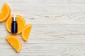 Bottles with orange fruit essential oil on wooden background. alternative medicine top view with copy space Royalty Free Stock Photo