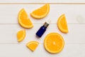 Bottles with orange fruit essential oil on wooden background. alternative medicine top view with copy space Royalty Free Stock Photo