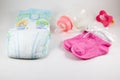 Bottles, pacifiers, and baby diaper on a white background Royalty Free Stock Photo