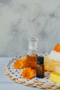 Bottles of pot marigold tincture or infusion and essential oil with fresh calendula flowers on a light background Royalty Free Stock Photo