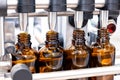 Bottles on the production line conveyor of the pharmaceutical industry. Machine for liquid drugs glassware bottling Royalty Free Stock Photo