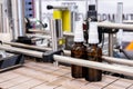 Bottles on the production line conveyor of the pharmaceutical industry. Machine for liquid drugs glassware bottling Royalty Free Stock Photo