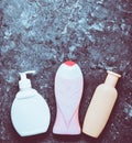 Bottles of products for showering on a black concrete surface. s