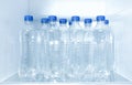 Bottles of water on shelf inside refrigerator Royalty Free Stock Photo