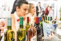 Bottles of red and rose wine from Serbia on display at a wine tasting stand in the center of Belgrade with a blurred client