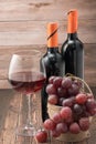 Bottles of red wine with red grape and wine Royalty Free Stock Photo