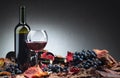 Bottles of red wine, grapes and dry vine leaves Royalty Free Stock Photo