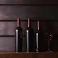 Bottles of red wine on a wooden shelf. banner background for winery, bar or shop Generative AI. Royalty Free Stock Photo